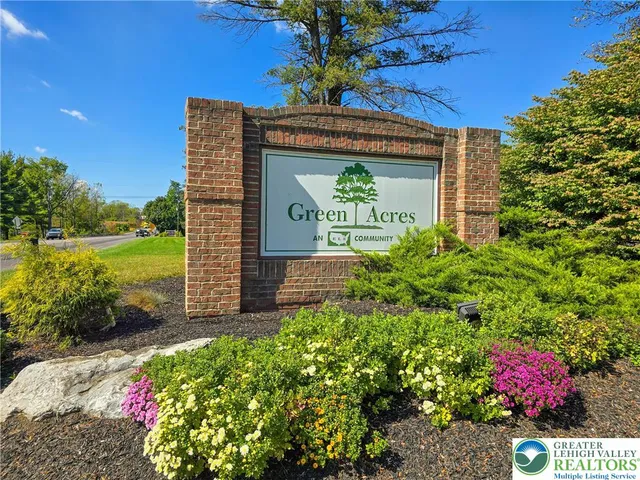 a sign that is sitting in front of flowers