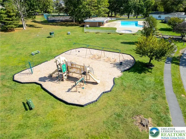 a view of a swimming pool with a yard