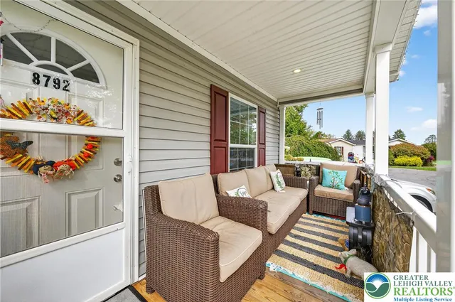a balcony with furniture and a potted plant
