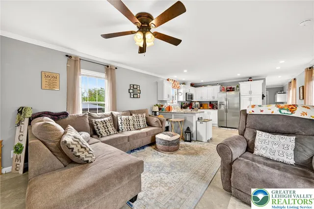 a living room with furniture gym equipment and a large window