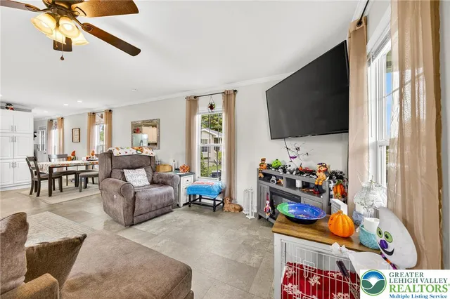 a living room filled with furniture and a flat screen tv