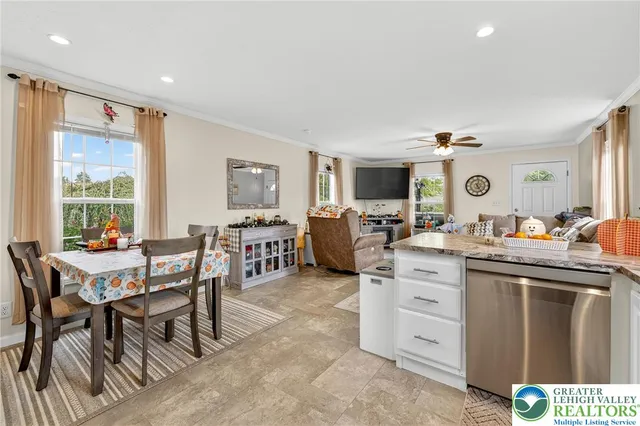 a living room with furniture a rug and a window