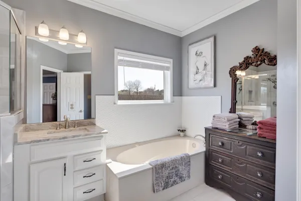 a bathroom with a sink vanity and a mirror