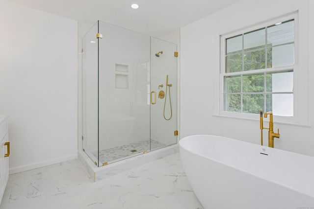 a bathroom with a bathtub and shower
