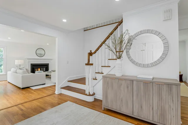 a living room with fireplace furniture and a wooden floor