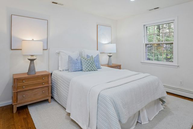 a bedroom with a bed and a lamp