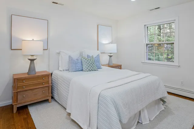 a bedroom with a bed and a lamp