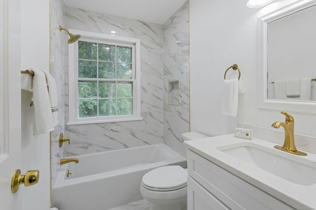 a bathroom with a sink a toilet and a bathtub