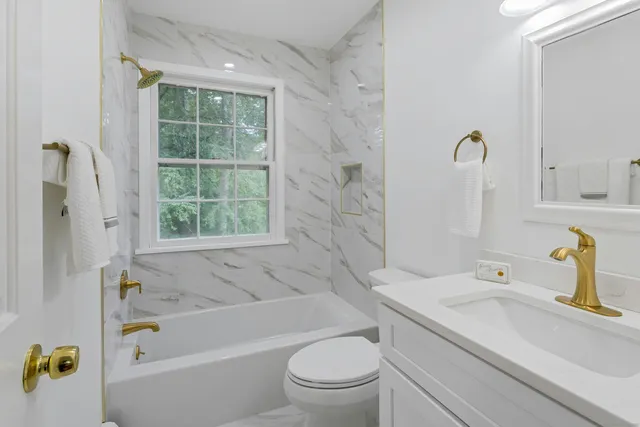 a bathroom with a sink a toilet and a bathtub