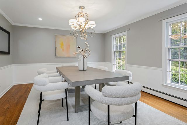 a view of a dining room with furniture and chandelier