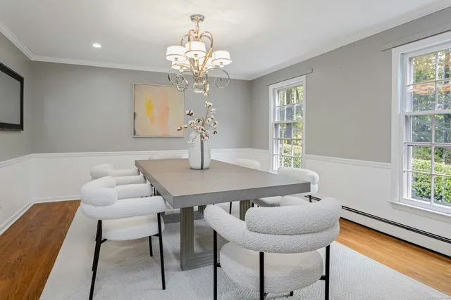 a view of a dining room with furniture and chandelier