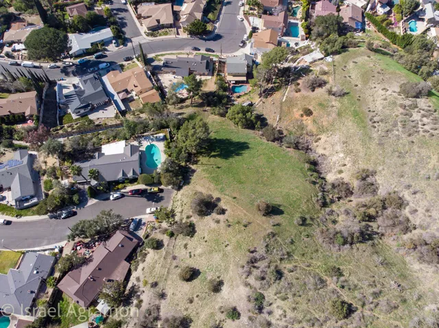 an aerial view of residential houses with outdoor space