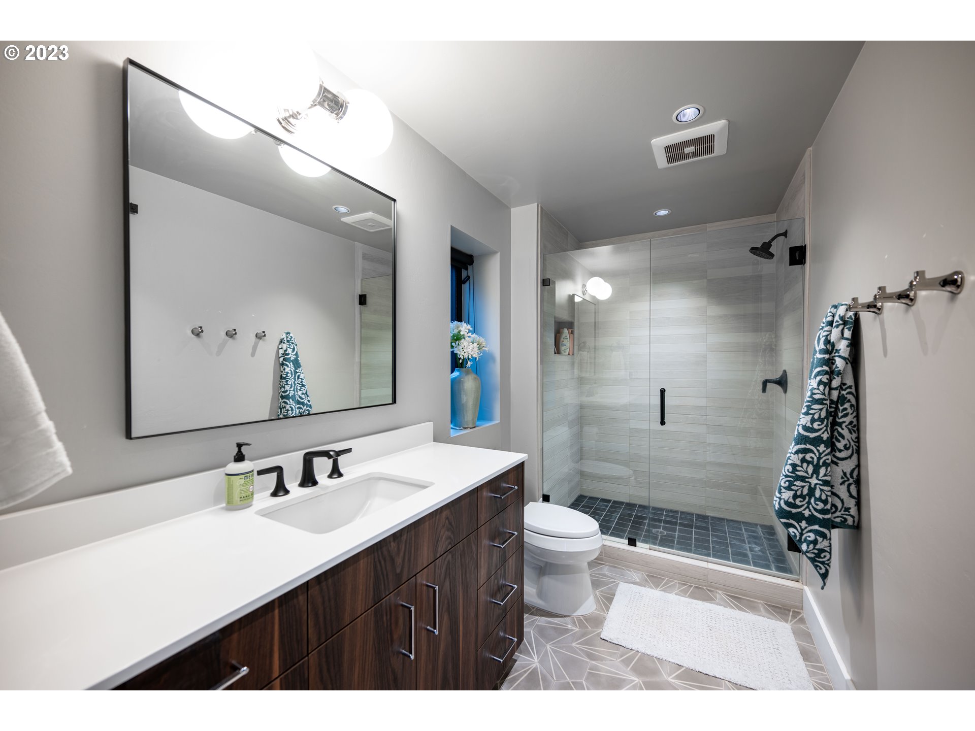 33723 Van Duyn Road Eugene, OR 97408 - Photo 38 of 48 a bathroom with a sink a toilet a mirror a vanity and shower