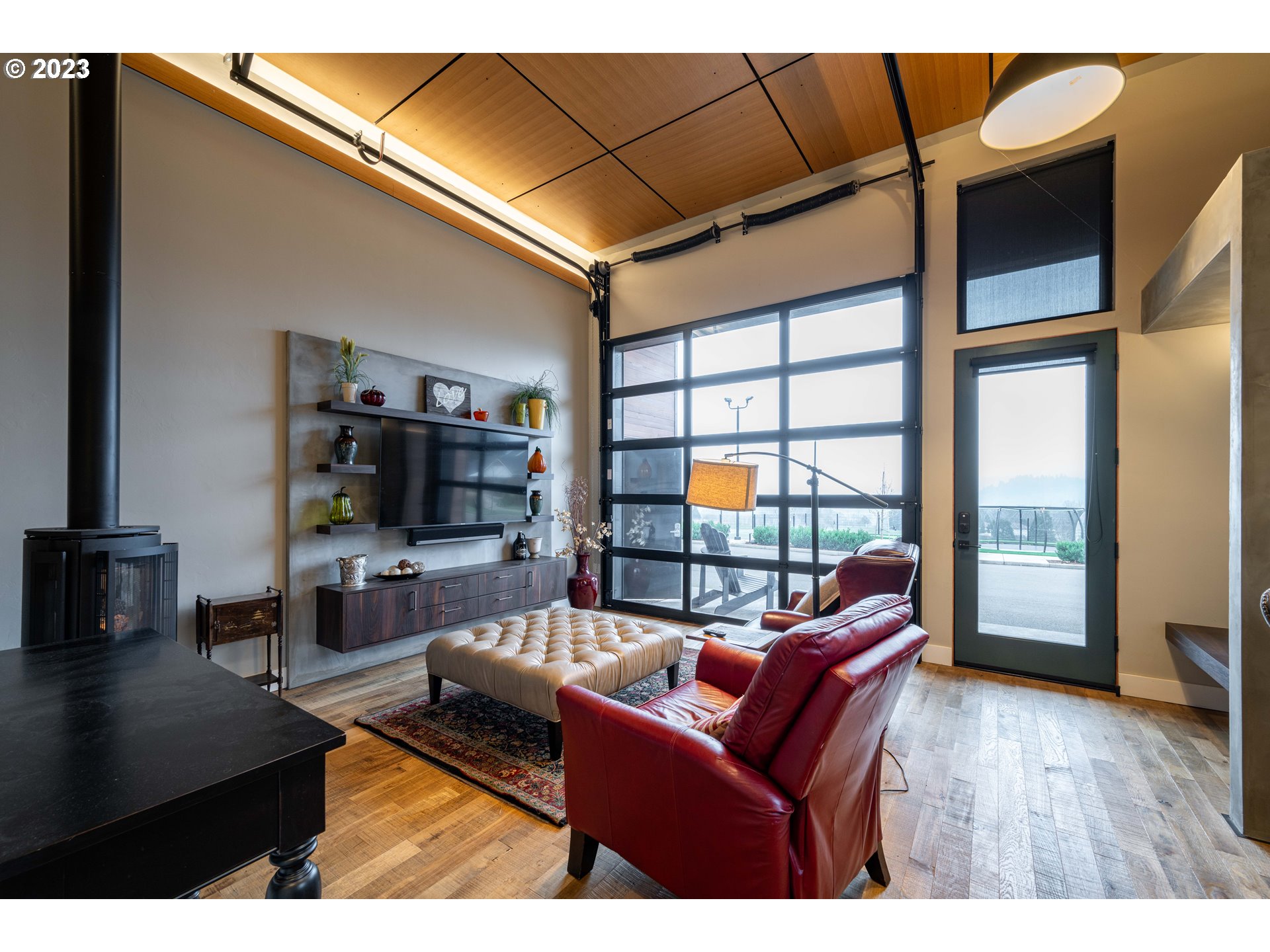 33723 Van Duyn Road Eugene, OR 97408 - Photo 39 of 48 a living room with furniture a flat screen tv and floor to ceiling window