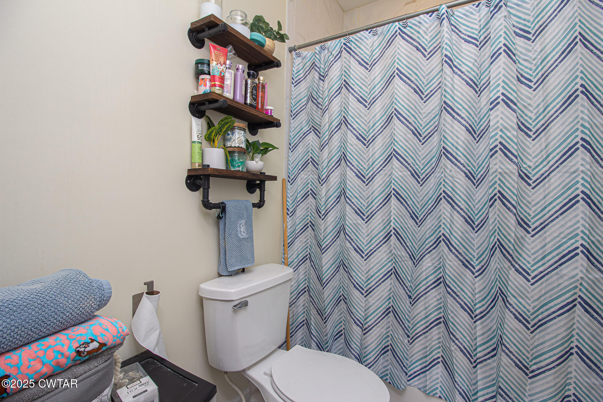 175 Ridgewood Drive Henderson, TN 38340 - Photo 24 of 43 a bathroom with a sink toilet and a shower curtain
