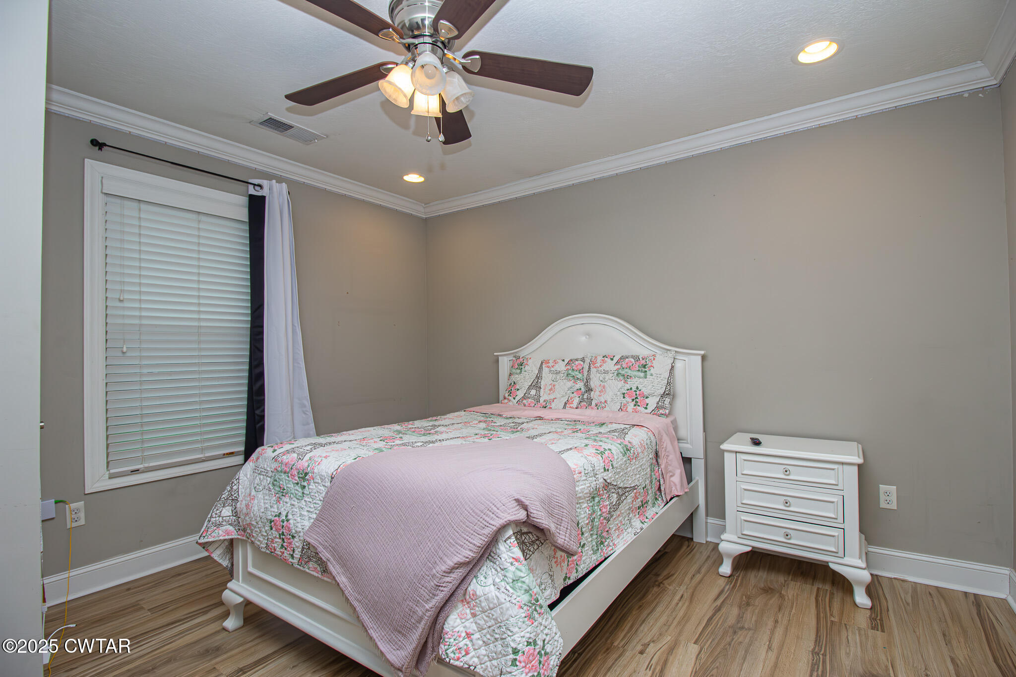 175 Ridgewood Drive Henderson, TN 38340 - Photo 28 of 43 a bedroom with a bed and a chandelier