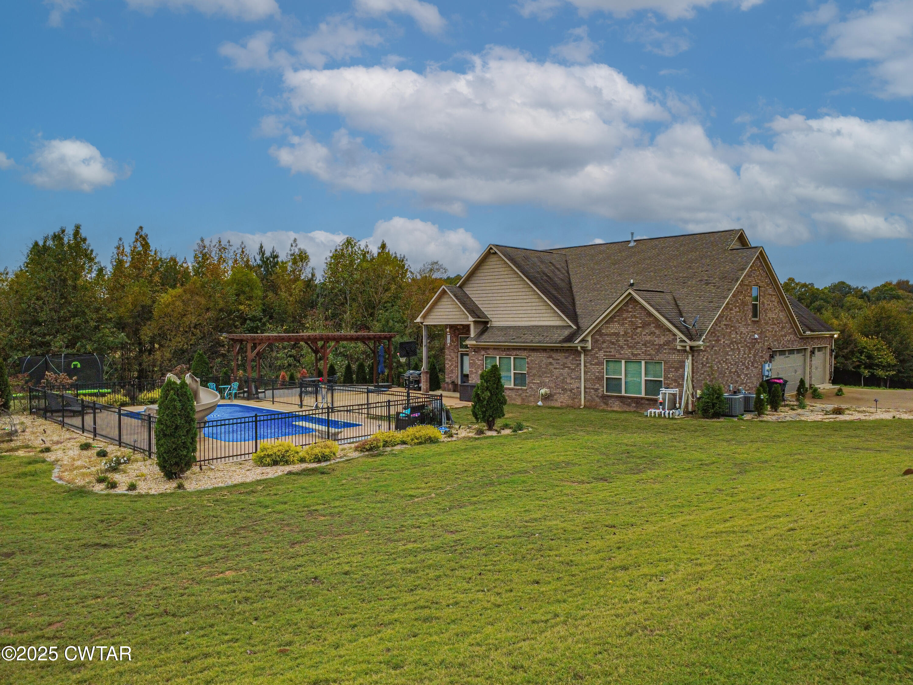 175 Ridgewood Drive Henderson, TN 38340 - Photo 39 of 43 a view of a house with a big yard and a large pool