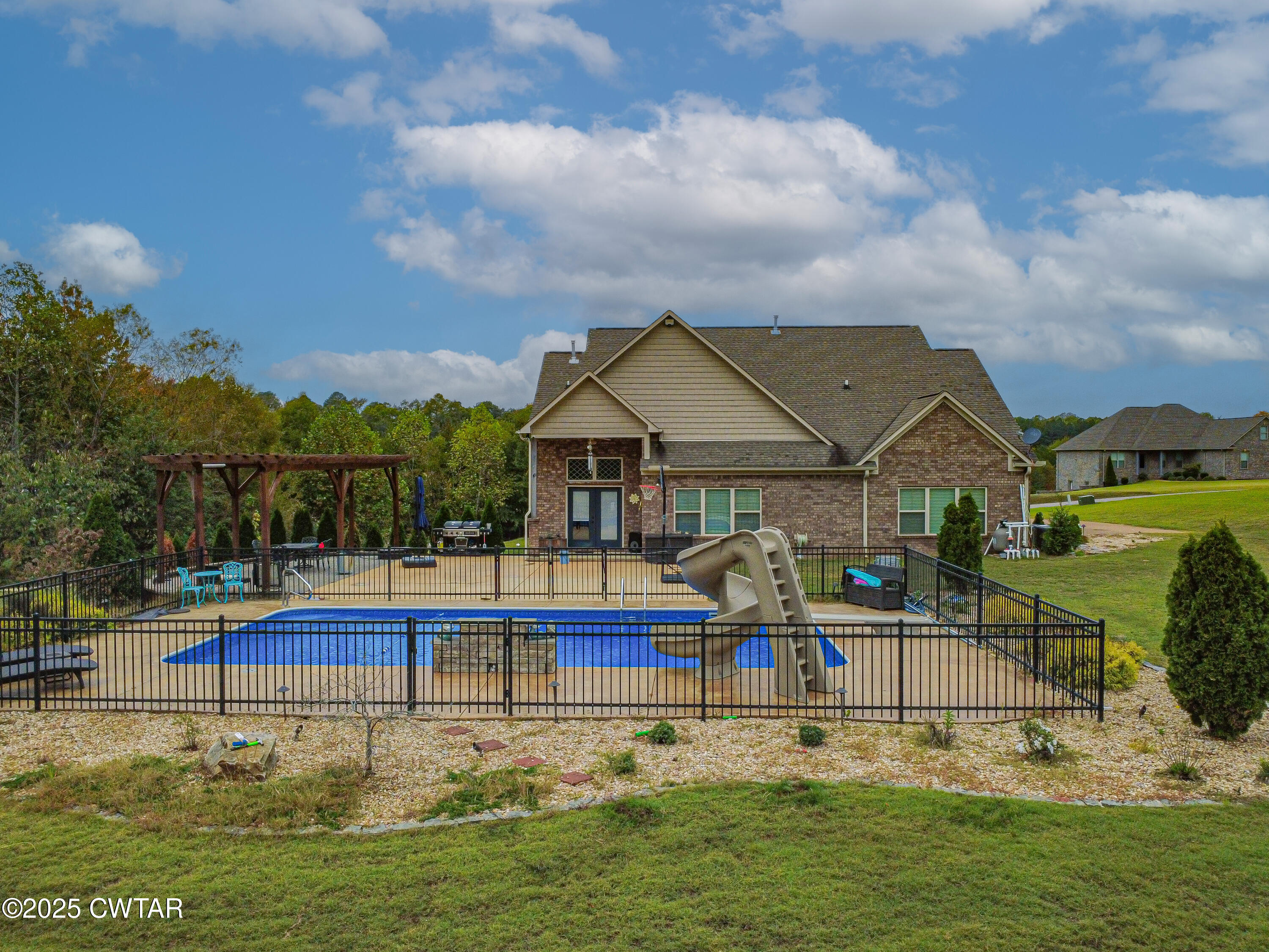 175 Ridgewood Drive Henderson, TN 38340 - Photo 40 of 43 a view of swimming pool with lawn chairs and large trees