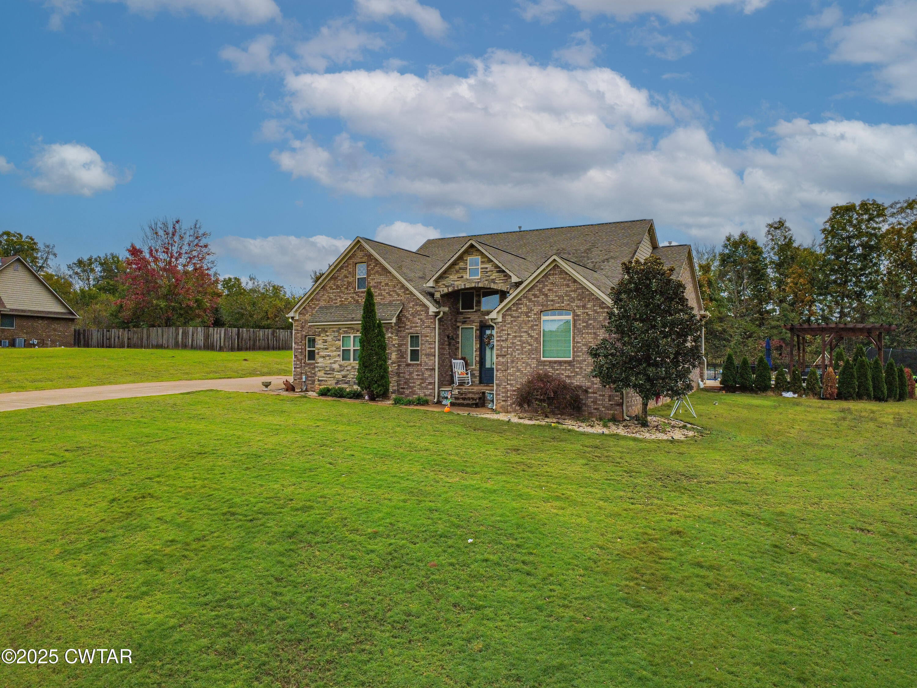 175 Ridgewood Drive Henderson, TN 38340 - Photo 5 of 43 a view of a house with a big yard and a large tree