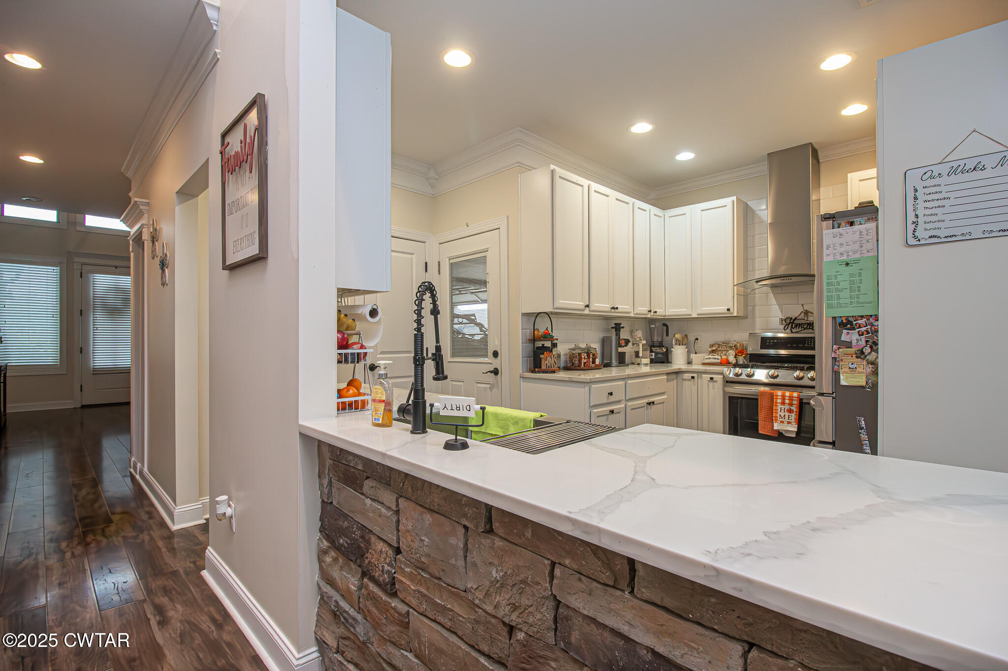 175 Ridgewood Drive Henderson, TN 38340 - Photo 7 of 43 a kitchen with stainless steel appliances a sink and a refrigerator
