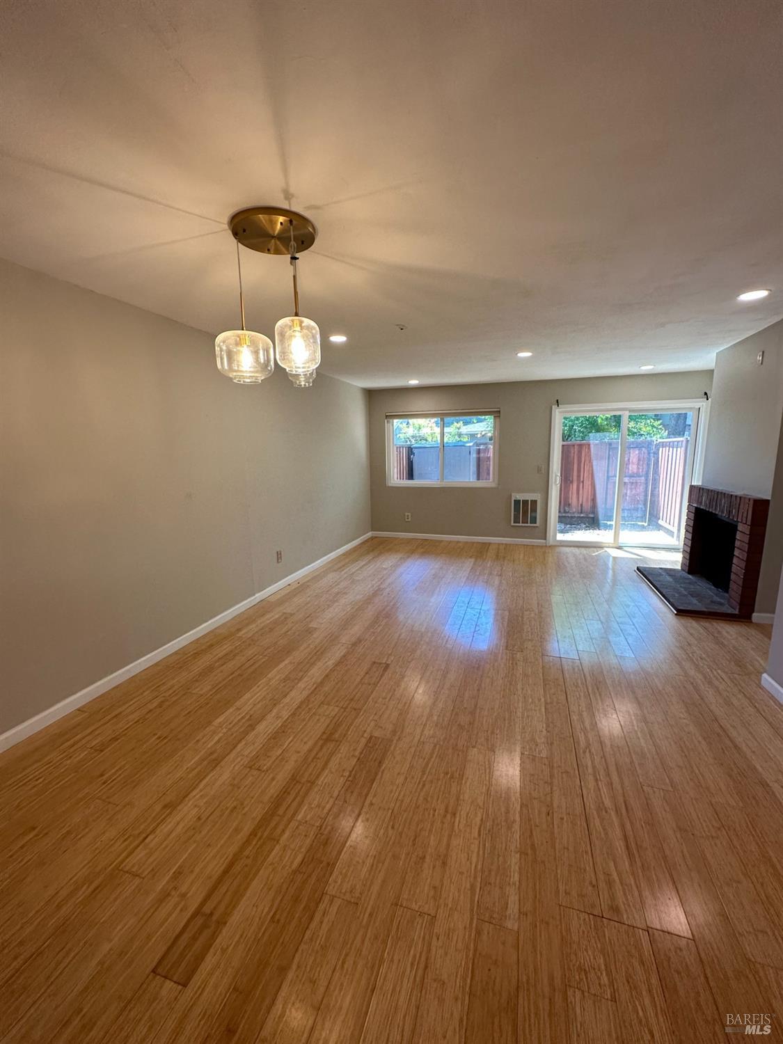 a view of wooden floor and a chandelier in a room