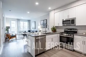 a kitchen with stainless steel appliances a stove sink microwave and cabinets