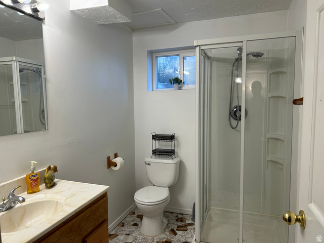 7659 State Street Midvale, UT 84047 - Photo 19 of 33 Bathroom featuring vanity and a stall shower
