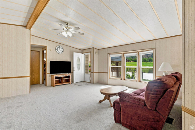 2405 Canyon Road Smithfield, UT 84335 - Photo 9 of 57 Expansive living area featuring light-toned paneling and wood-finish ceiling beams