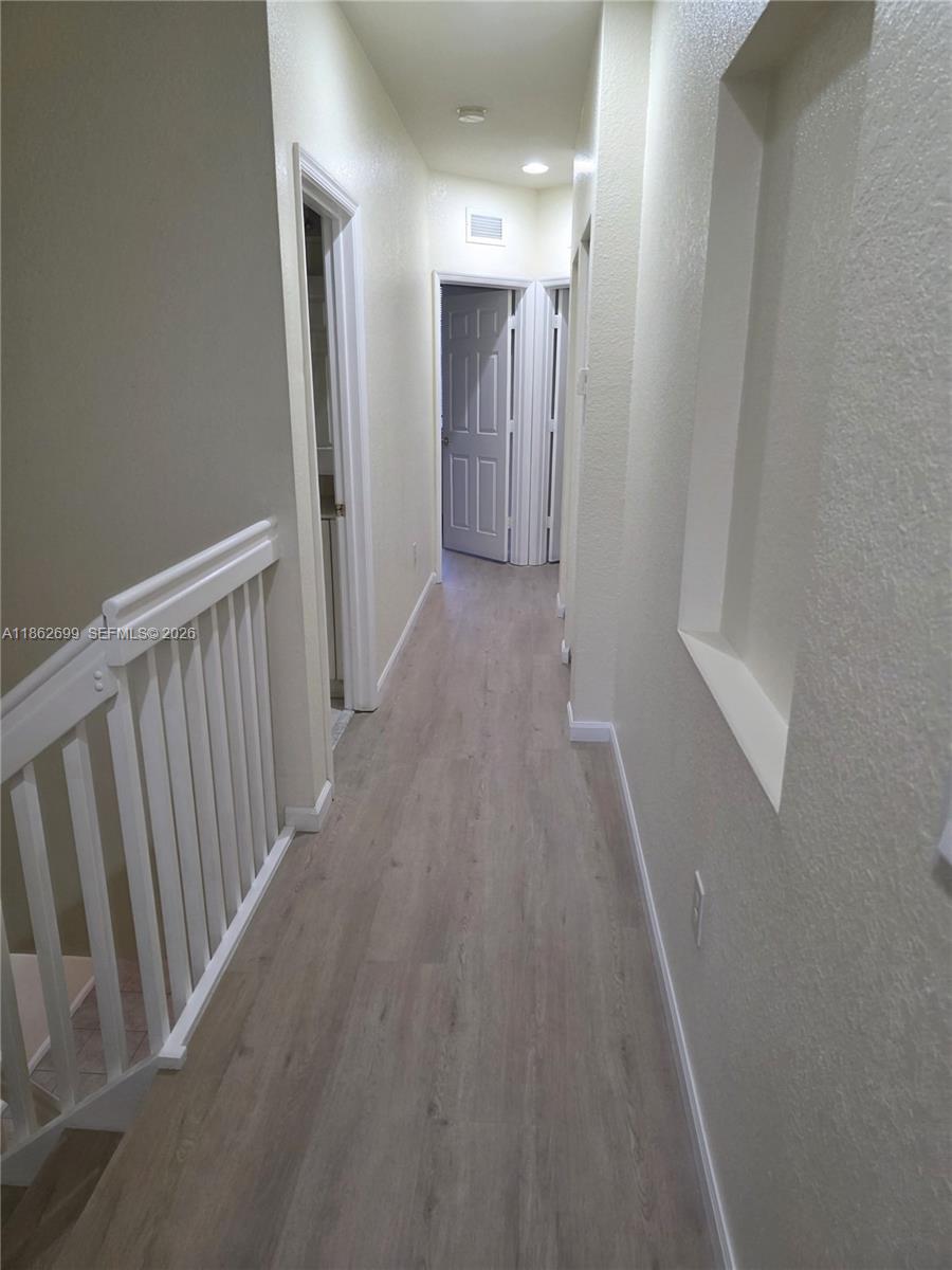 2584 Southwest 84th Terrace, Unit 101 Miramar, FL 33025 - Photo 12 of 19 a view of a hallway with wooden floor