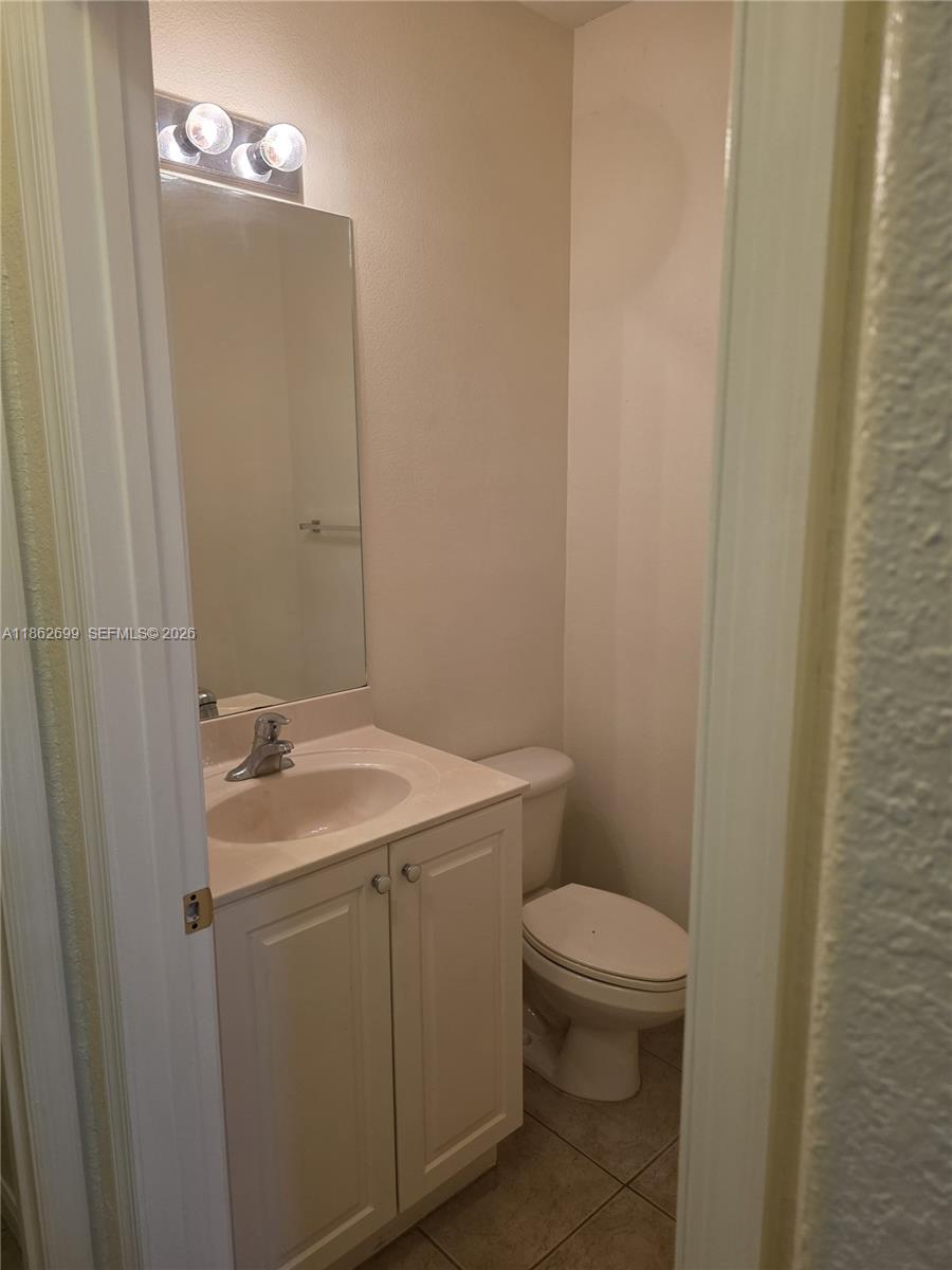 2584 Southwest 84th Terrace, Unit 101 Miramar, FL 33025 - Photo 15 of 19 a bathroom with a sink a toilet and mirror