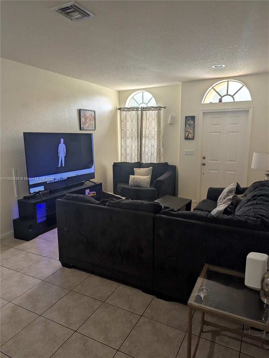 2584 Southwest 84th Terrace, Unit 101 Miramar, FL 33025 - Photo 2 of 11 a living room with furniture