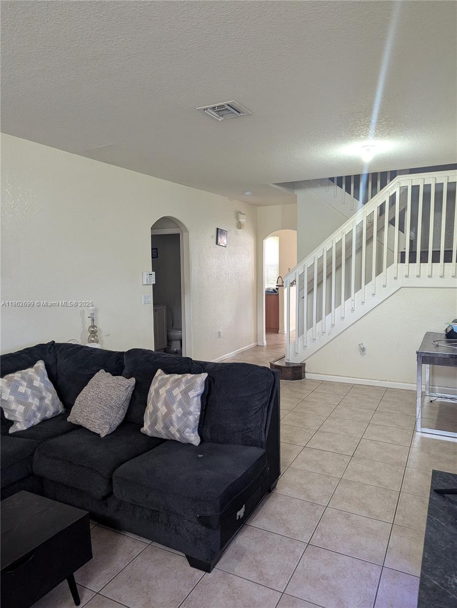 2584 Southwest 84th Terrace, Unit 101 Miramar, FL 33025 - Photo 3 of 11 a living room with furniture and stairs