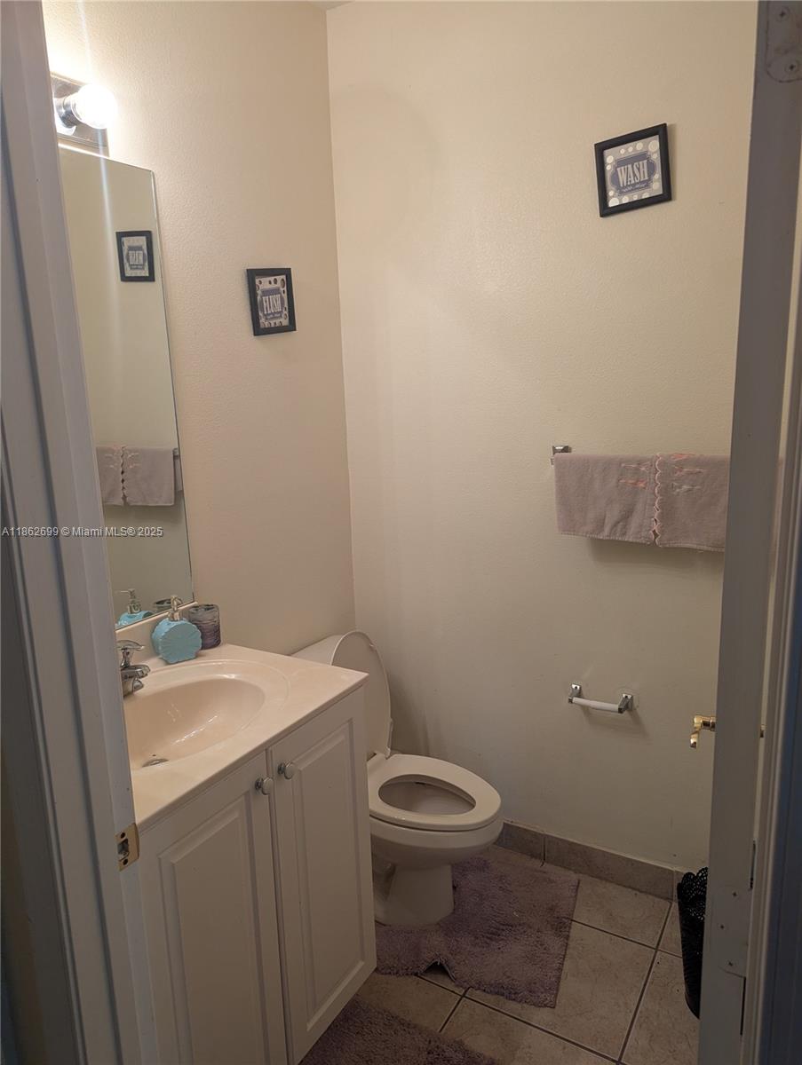 2584 Southwest 84th Terrace, Unit 101 Miramar, FL 33025 - Photo 4 of 11 a bathroom with a toilet sink and mirror