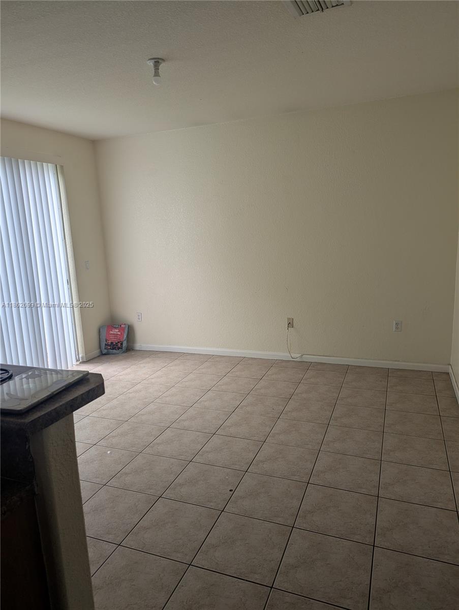2584 Southwest 84th Terrace, Unit 101 Miramar, FL 33025 - Photo 5 of 11 a view of an empty room and window