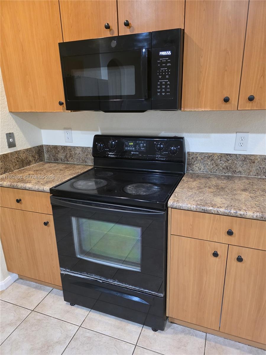 2584 Southwest 84th Terrace, Unit 101 Miramar, FL 33025 - Photo 6 of 19 a stove top oven sitting inside of a kitchen