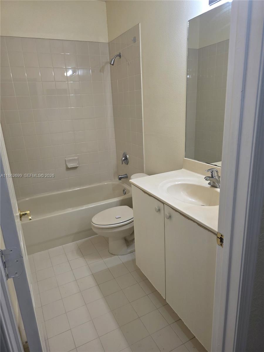 2584 Southwest 84th Terrace, Unit 101 Miramar, FL 33025 - Photo 8 of 19 a bathroom with a sink a toilet and shower