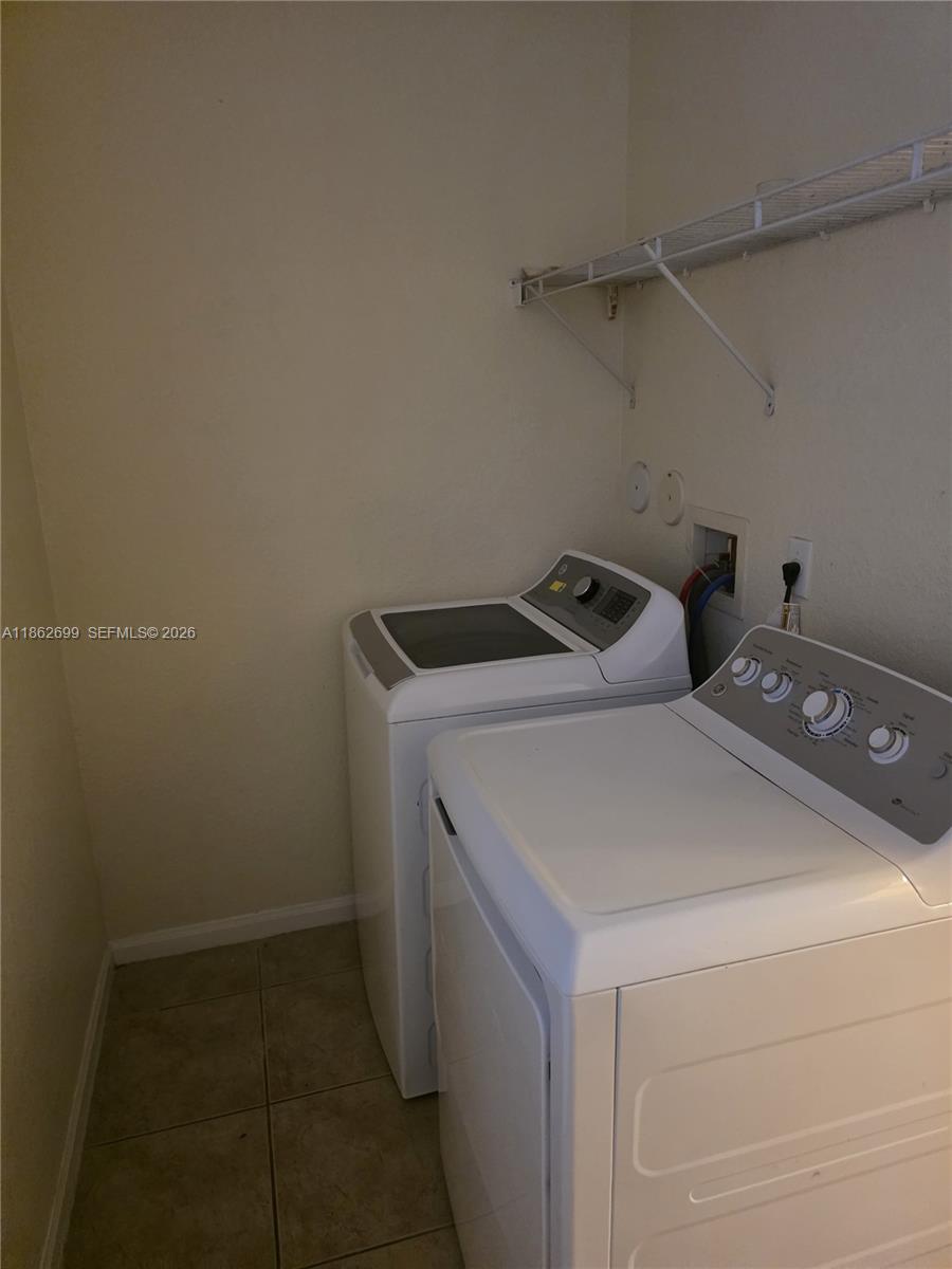 2584 Southwest 84th Terrace, Unit 101 Miramar, FL 33025 - Photo 9 of 19 a utility room with dryer and washer