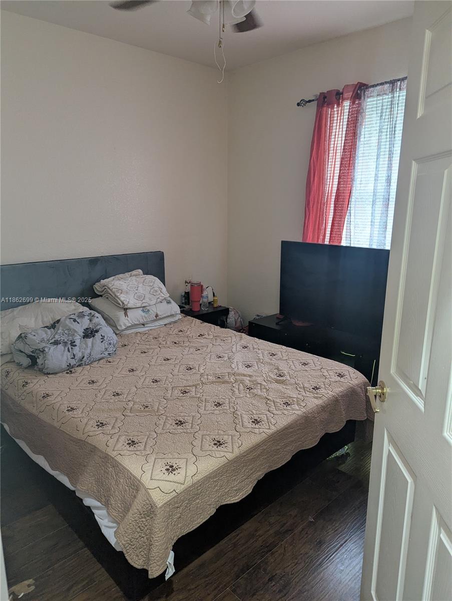 2584 Southwest 84th Terrace, Unit 101 Miramar, FL 33025 - Photo 10 of 11 a bed sitting in a bedroom next to a window