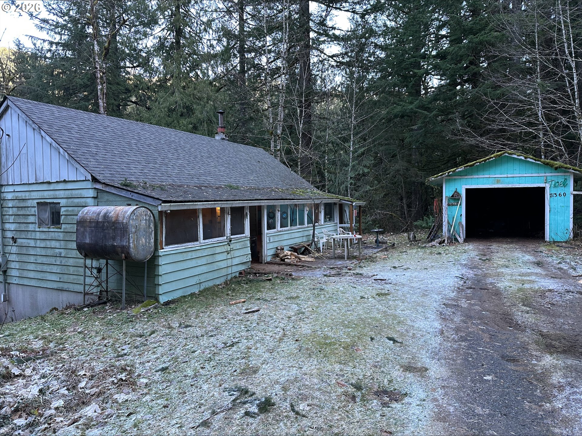 71360 East Jennie Lane Rhododendron, OR 97049 - Photo 1 of 19 a front view of a house with a garden and yard