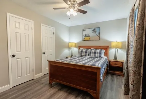 a bedroom with a bed and a chandelier