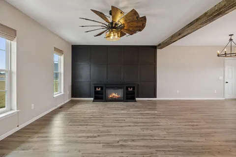 a view of a kitchen with furniture and wooden floor