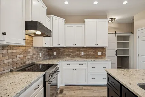 a spacious bedroom with a bed and a potted plant