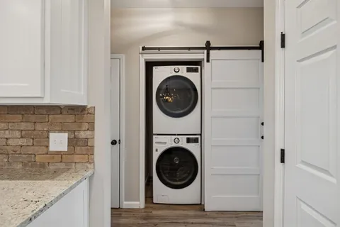a view of a livingroom with a ceiling fan & windows