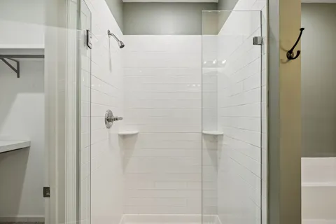 an empty room with windows and ceiling fan