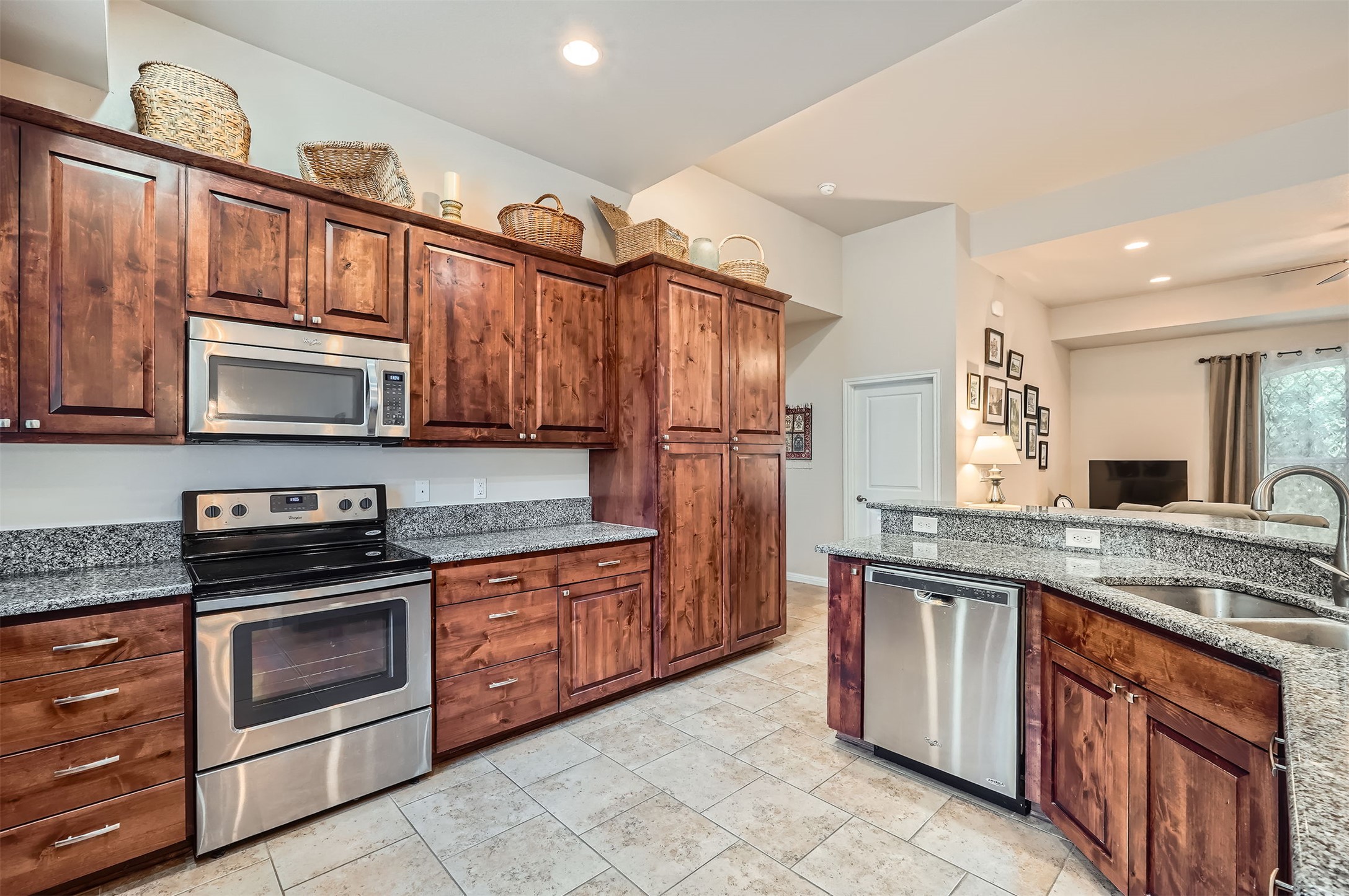 5501 Hitching Post Lago Vista, TX 78645 - Photo 11 of 26 a kitchen with stainless steel appliances granite countertop a stove microwave and cabinets