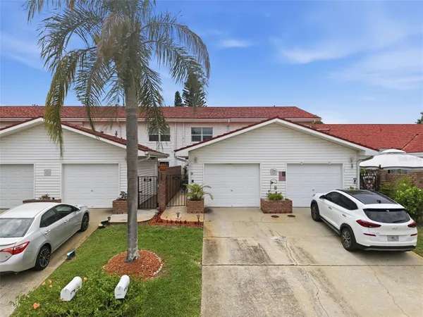 a couple of cars parked in front of a house