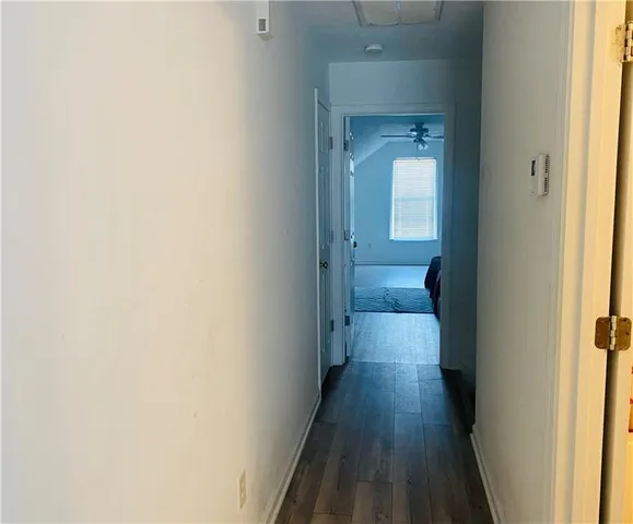 a view of a hallway with wooden floor