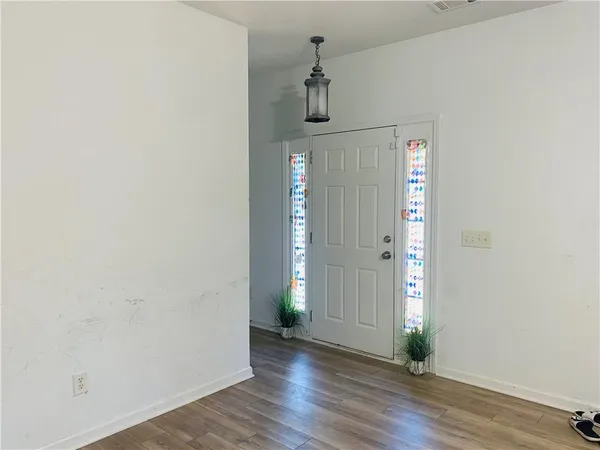 a view of a hallway with wooden floor