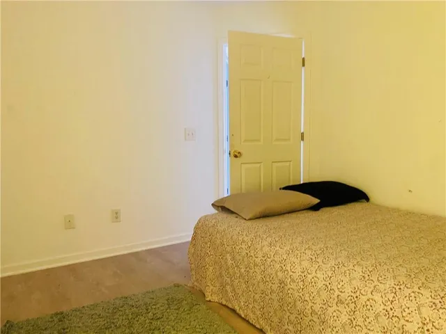 a bedroom with a bed and a wall painting