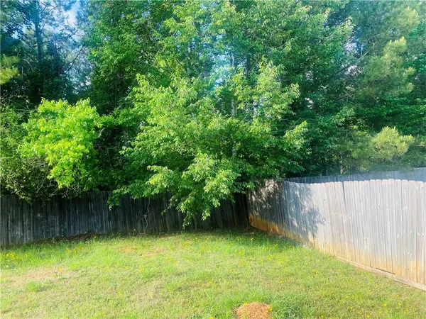 a view of a yard with a tree